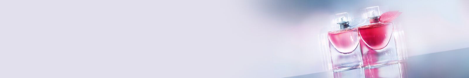 Two elegant perfume bottles with a pink liquid, set against a soft, light background.