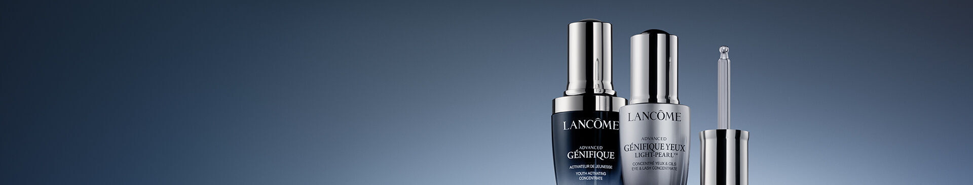 Two luxury skincare serums from Lancome on a gradient background, featuring sleek, modern packaging with silver and black accents. The products include an activating concentrate and an eye treatment.