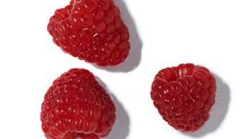 Three bright red raspberries arranged on a white background.