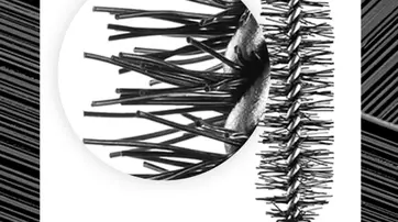 Close-up of a black mascara brush showing densely packed bristles, with a zoomed-in section highlighting the texture and arrangement of the bristles for detail.
