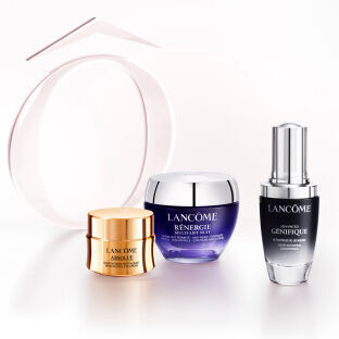 Three skincare products from Lancome are displayed: a golden cream jar labeled "Absolue," a purple jar labeled "Renergie," and a black serum bottle labeled "Genifique." A soft, curved ribbon element is in the background.