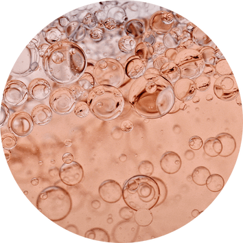 Bulles d'air flottant dans un liquide rose, creant une texture legere et petillante.