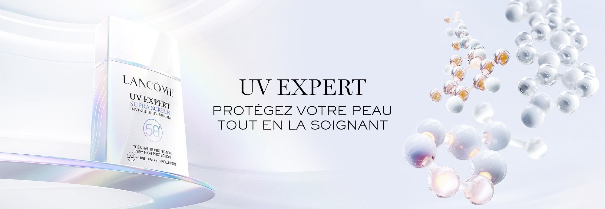 Flacon de soin solaire Lancôme UV Expert avec des bulles illustrant la protection et le soin de la peau.